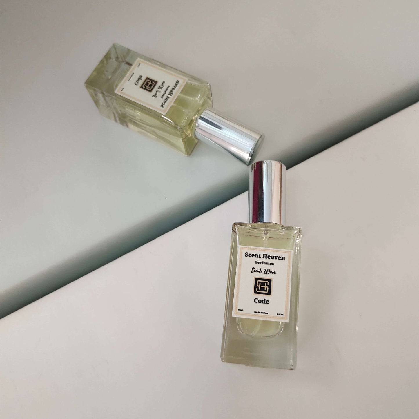 A sleek and masculine bottle of Code Perfume for Men, exuding modern sophistication. The fragrance blends fresh citrus, warm spices, and smooth woody notes, creating a bold and timeless scent. Perfect for the confident man seeking elegance and long-lasting freshness.