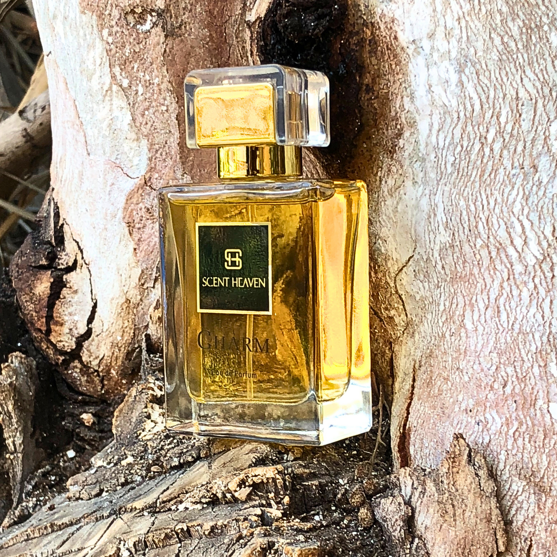 A luxurious bottle of CHARM perfume, a floral fragrance for women featuring notes of peony, rose, and osmanthus. Perfect for elegant, everyday wear.